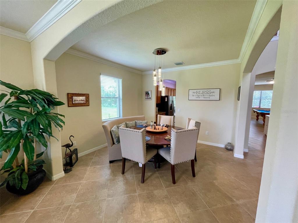 20940 Valore Court Venice, FL 34293 - Photo 6 of 52 a view of a dining room with furniture and a potted plant