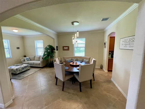 a dining room with furniture and window