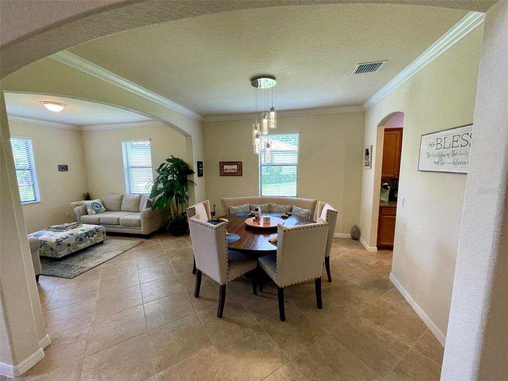 20940 Valore Court Venice, FL 34293 - Photo 8 of 52 a dining room with furniture and window