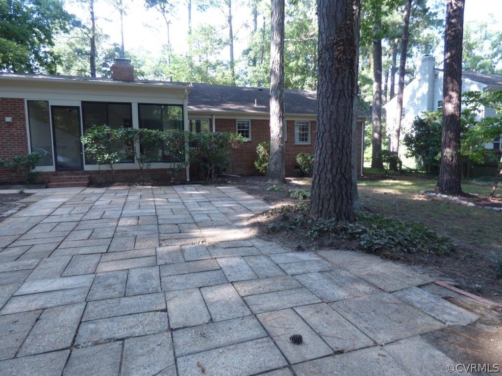 8953 Bellefonte Road Henrico, VA 23229 - Photo 11 of 12 Back of the Sun Room with doors to the large patio with pavers that also has a pathway to the detached 2 car garage pedestrian door..