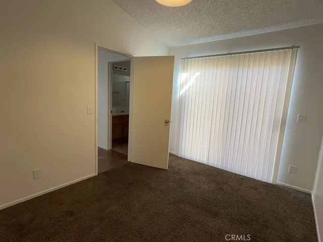 a bathroom with a granite countertop sink a toilet and a mirror