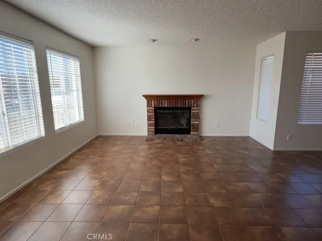 a view of empty room with a fireplace