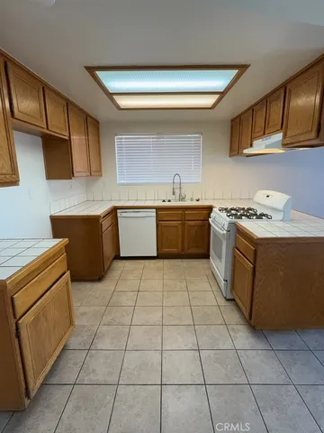 a kitchen with a stove a sink and a refrigerator
