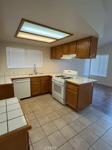 a kitchen with stainless steel appliances granite countertop a stove and a sink