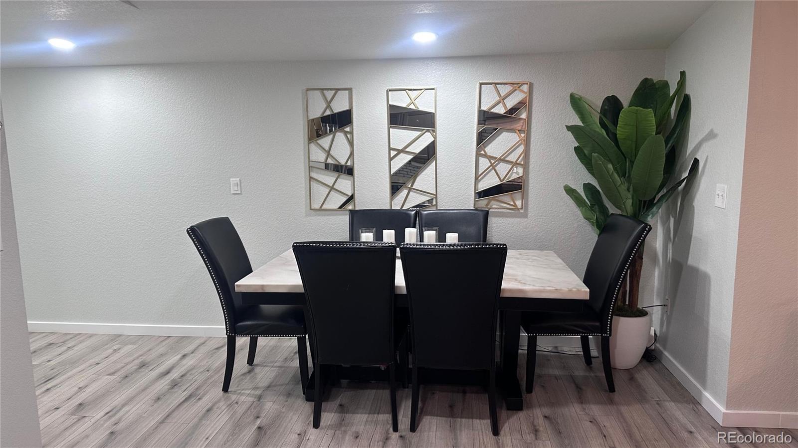 2612 Swale Run Colorado Springs, CO 80916 - Photo 11 of 25 a view of a dining room with furniture and wooden floor