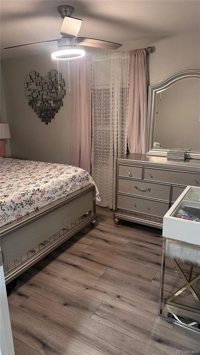 2612 Swale Run Colorado Springs, CO 80916 - Photo 15 of 25 a bedroom with a bed and a dresser