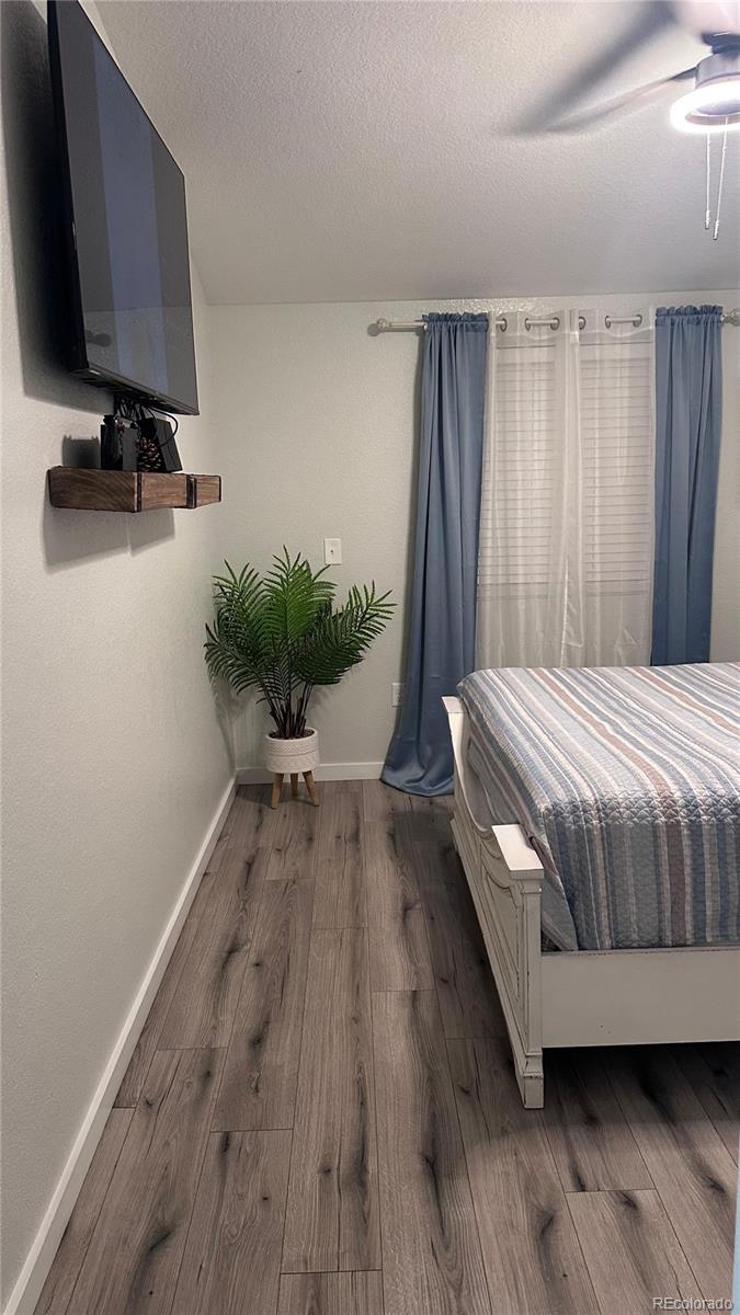 2612 Swale Run Colorado Springs, CO 80916 - Photo 16 of 25 a bedroom with a bed and a flat screen tv