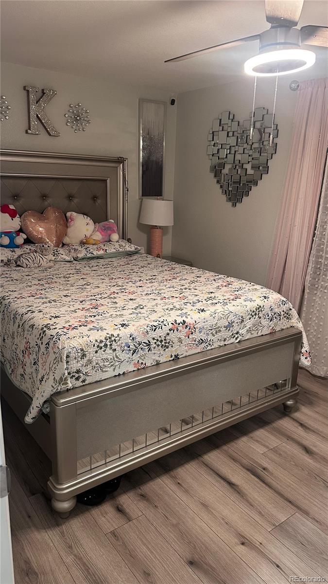 2612 Swale Run Colorado Springs, CO 80916 - Photo 17 of 25 a bed sitting in a bedroom next to a cabinet