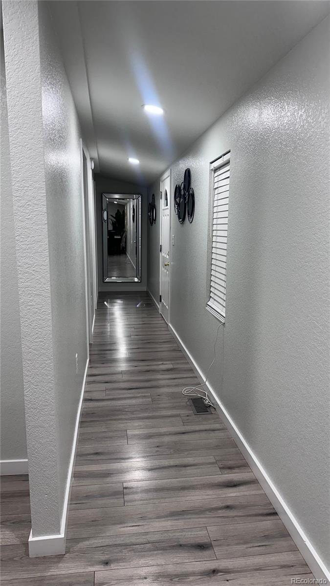 2612 Swale Run Colorado Springs, CO 80916 - Photo 19 of 25 a view of gallery with wooden floor