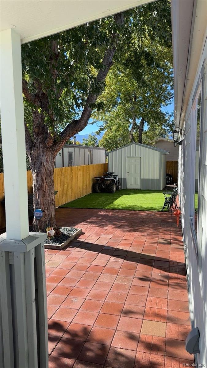 2612 Swale Run Colorado Springs, CO 80916 - Photo 20 of 25 a backyard of a house with lots of green space