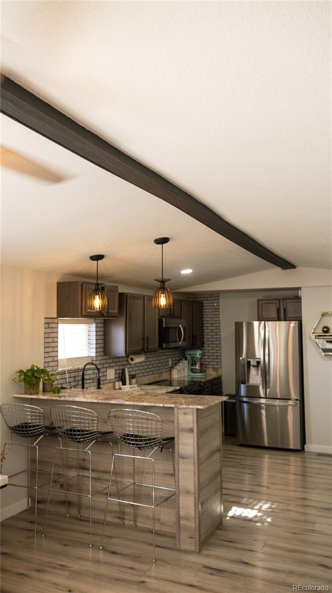 2612 Swale Run Colorado Springs, CO 80916 - Photo 25 of 25 a view of kitchen with counter top stainless steel appliances and cabinets