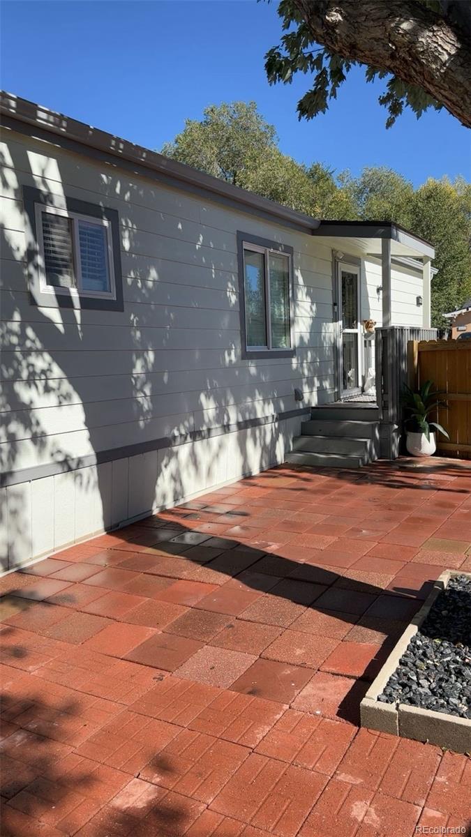 2612 Swale Run Colorado Springs, CO 80916 - Photo 4 of 25 a view of a house with backyard and sitting area