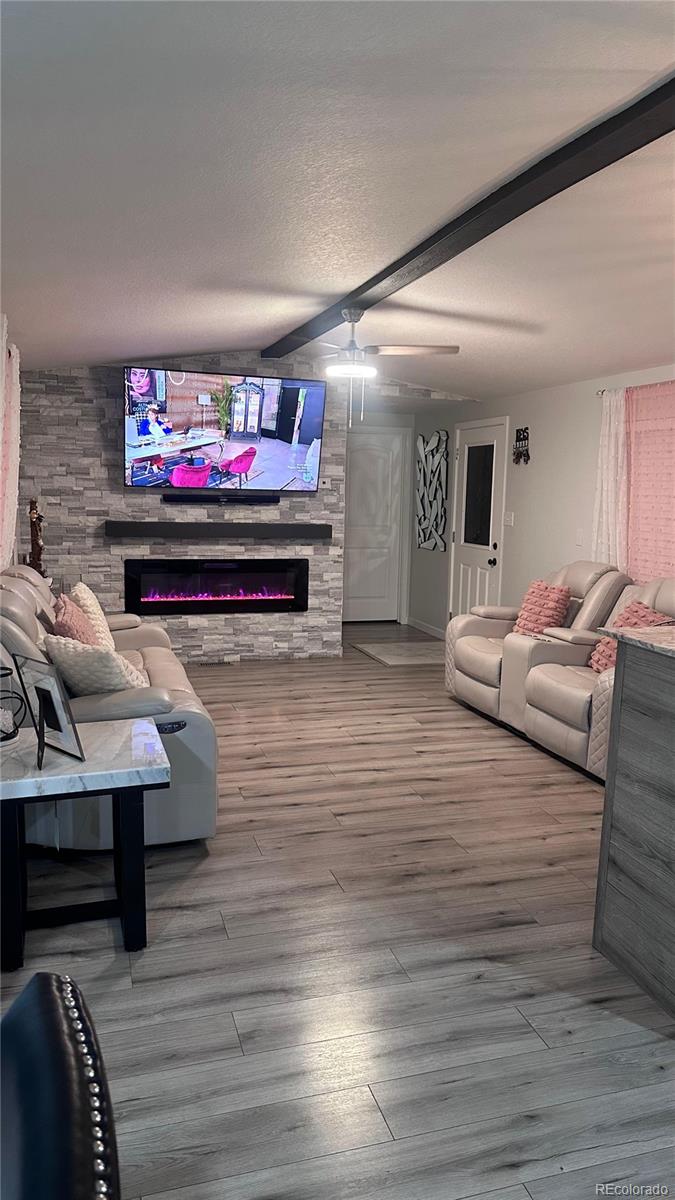 2612 Swale Run Colorado Springs, CO 80916 - Photo 7 of 25 a living room with furniture and a flat screen tv