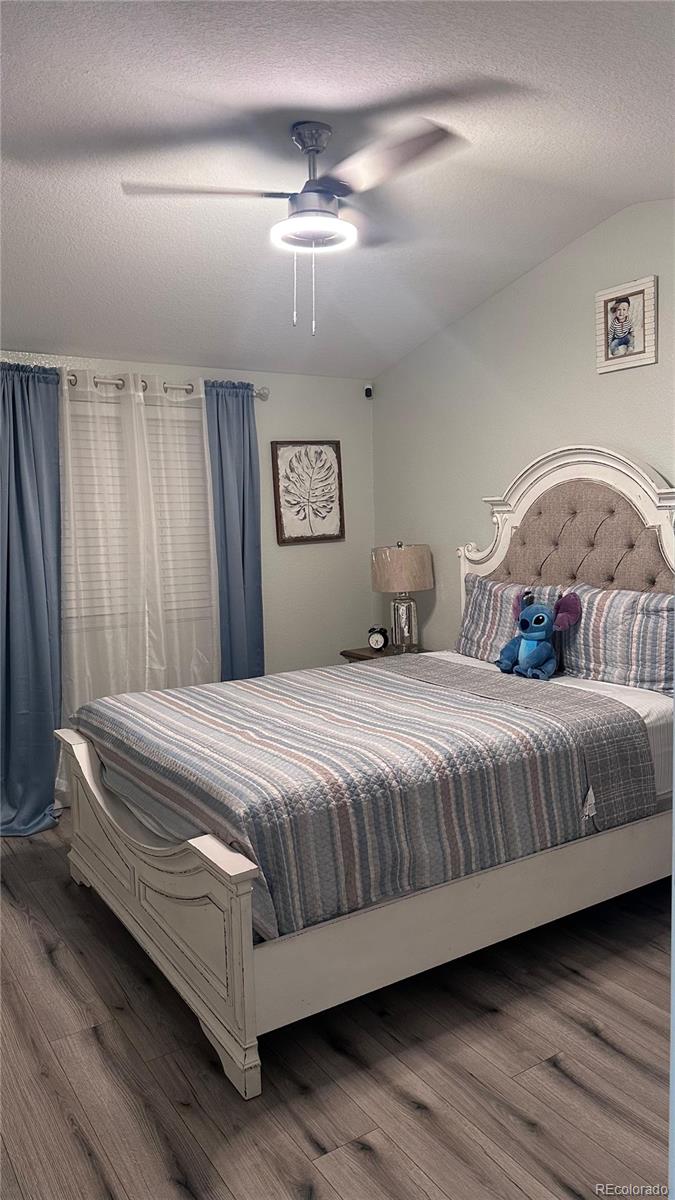 2612 Swale Run Colorado Springs, CO 80916 - Photo 8 of 25 a bedroom with a bed and window