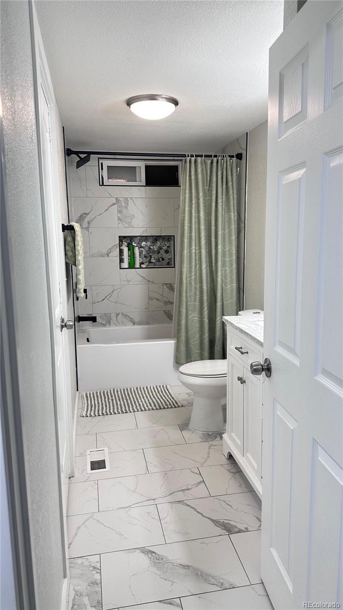 2612 Swale Run Colorado Springs, CO 80916 - Photo 10 of 25 a bathroom with a toilet a sink and a mirror