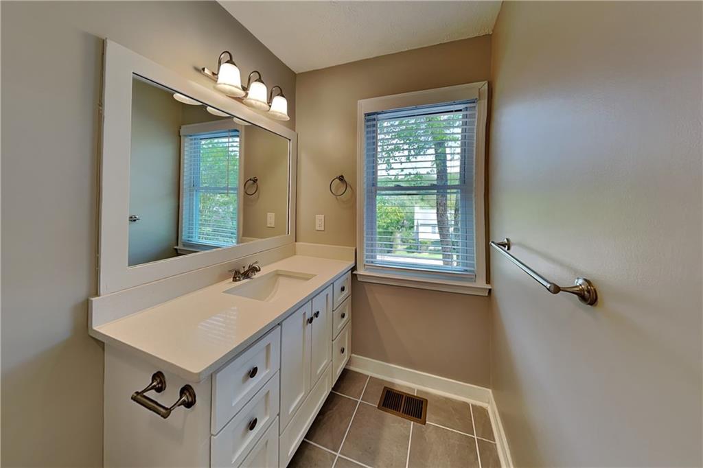 10610 Colony Glen Drive Alpharetta, GA 30022 - Photo 11 of 22 a bathroom with a sink and a mirror