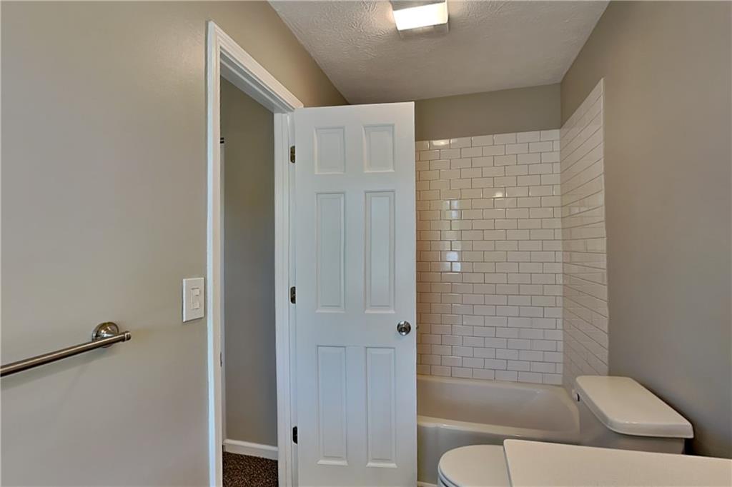 10610 Colony Glen Drive Alpharetta, GA 30022 - Photo 12 of 22 a bathroom with a toilet and a shower