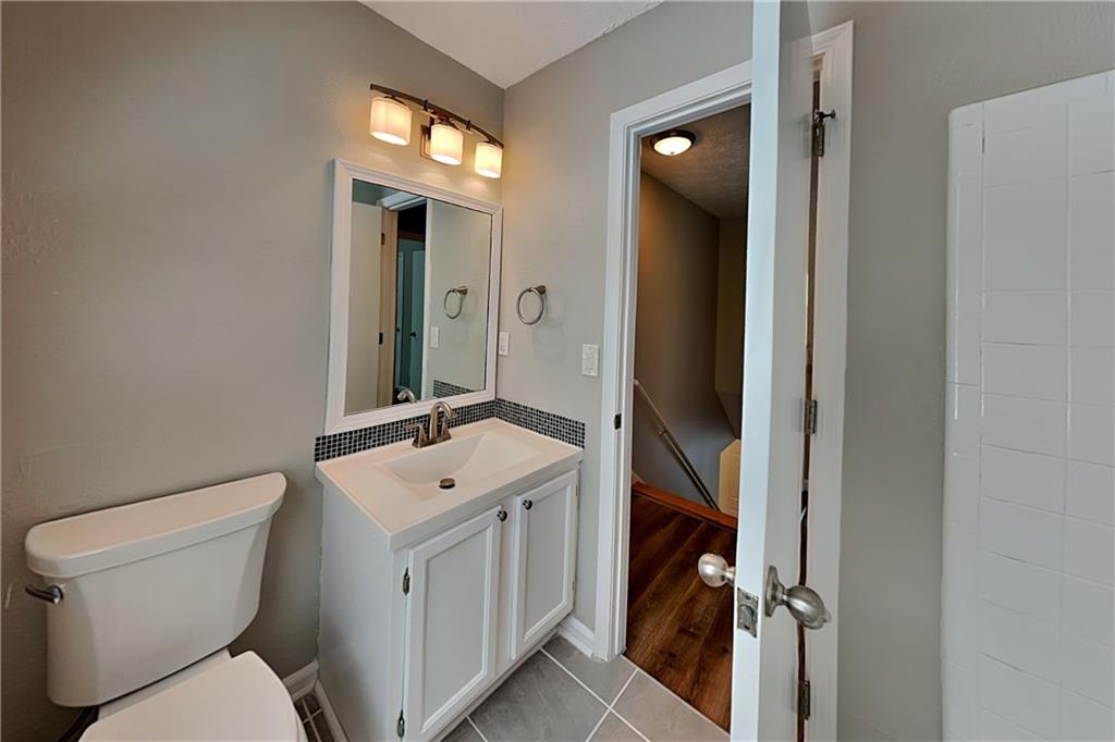 10610 Colony Glen Drive Alpharetta, GA 30022 - Photo 18 of 22 a bathroom with a toilet sink and mirror