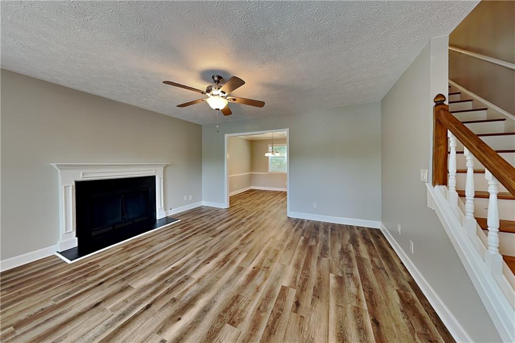 10610 Colony Glen Drive Alpharetta, GA 30022 - Photo 2 of 22 a view of an empty room with a fireplace and a window