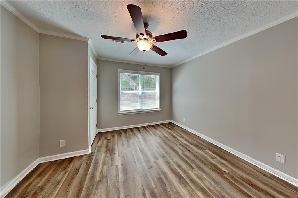 10610 Colony Glen Drive Alpharetta, GA 30022 - Photo 7 of 22 wooden floor in an empty room with a window