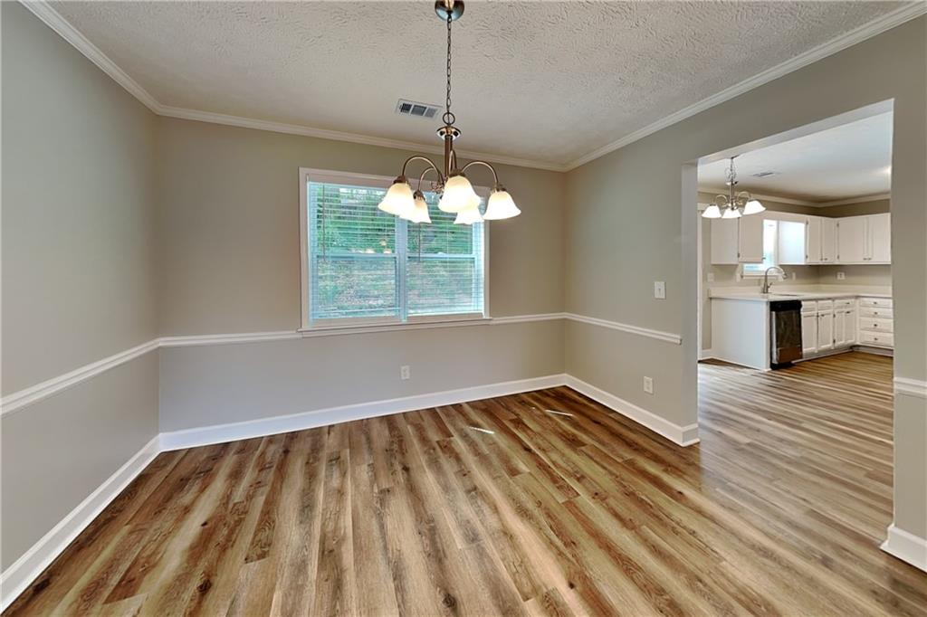 10610 Colony Glen Drive Alpharetta, GA 30022 - Photo 8 of 22 a view of an empty room with wooden floor and a window