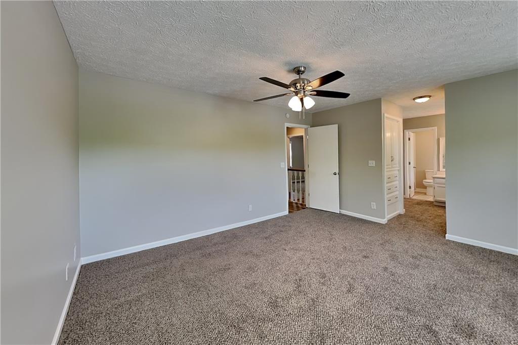 10610 Colony Glen Drive Alpharetta, GA 30022 - Photo 9 of 22 an empty room with fan and a ceiling fan