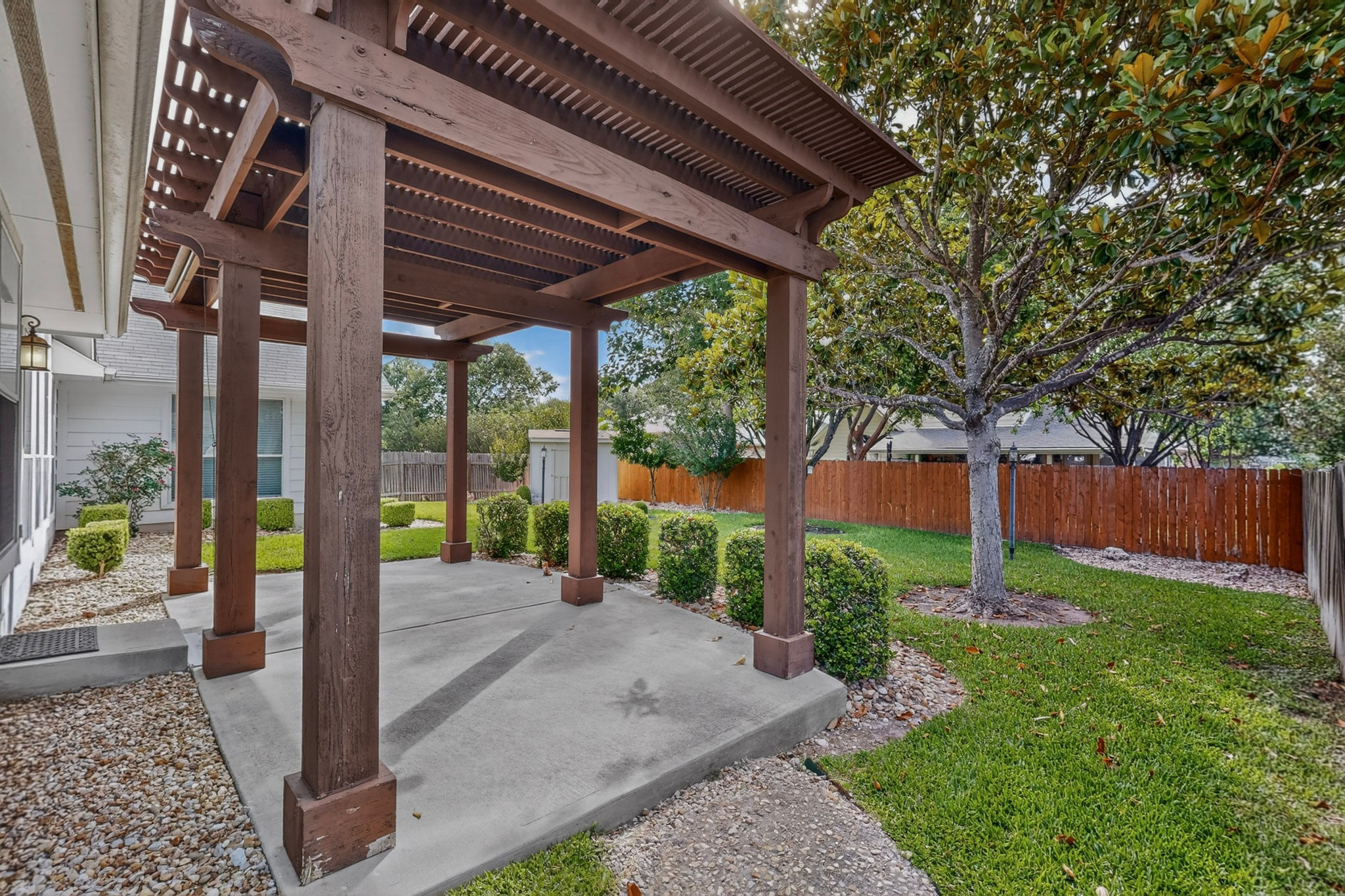 905 Victoria Ridge Drive Pflugerville, TX 78660 - Photo 28 of 32 A spacious patio area with a wooden pergola invites outdoor relaxation.