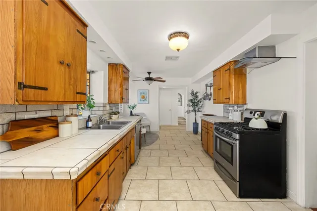 a large kitchen with stainless steel appliances granite countertop a sink and cabinets