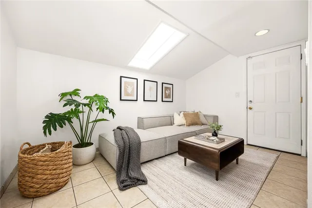 a living room with furniture and a potted plant