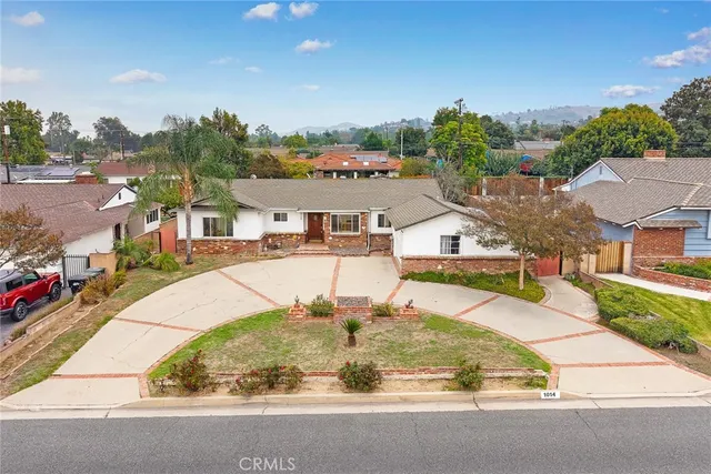 an aerial view of residential houses with outdoor space and street view