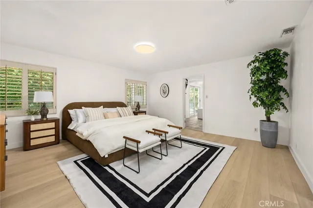 a bedroom with a bed and a potted plant