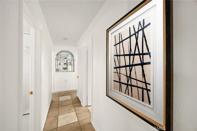 a view of a hallway with wooden floor and windows