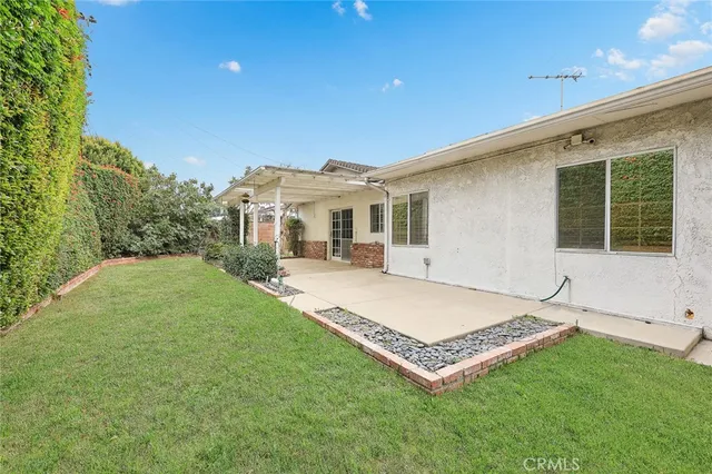 a view of a house with a backyard and porch