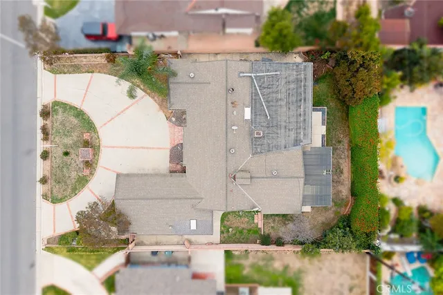 an aerial view of a house with a yard and a fountain