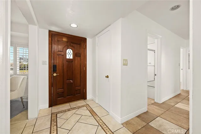 a view of a hallway with bathroom and a sink