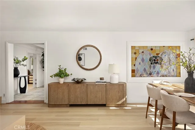 a living room with furniture a wall paintings and a large window