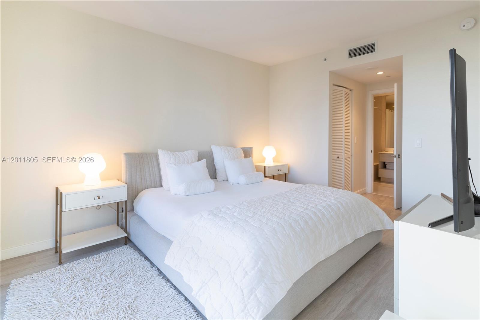 55 Southwest 9th Street, Unit 3404 Miami, FL 33130 - Photo 11 of 25 a bedroom with bed and window