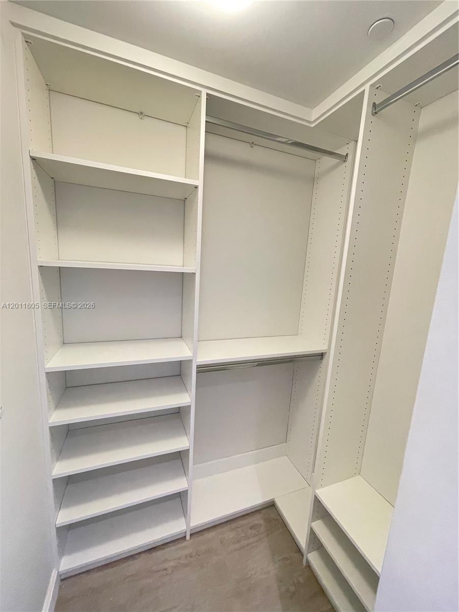 55 Southwest 9th Street, Unit 3404 Miami, FL 33130 - Photo 17 of 25 a view of walk in closet with empty racks