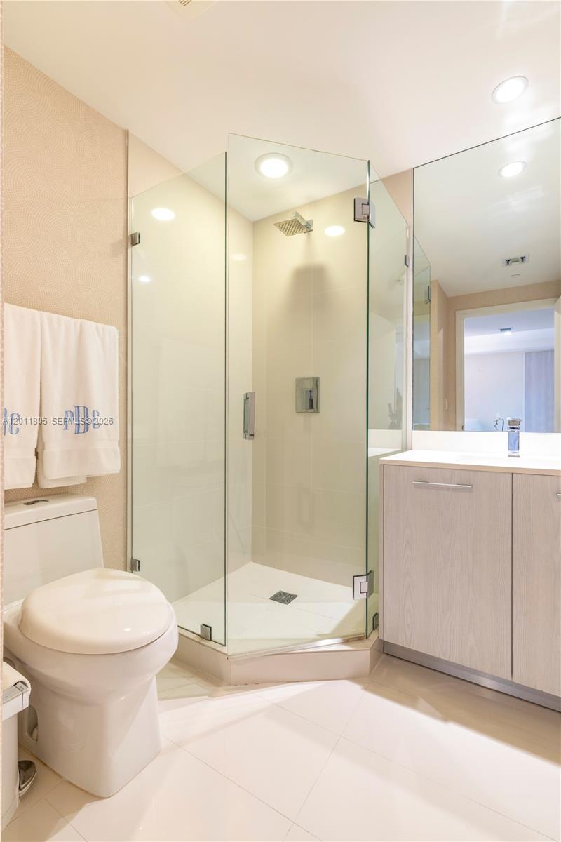 55 Southwest 9th Street, Unit 3404 Miami, FL 33130 - Photo 23 of 25 a bathroom with a shower a toilet and a sink