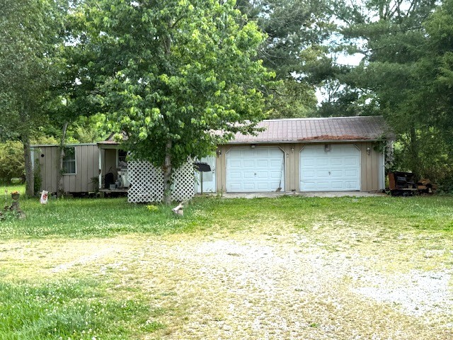 170 Markeele Road Manchester, TN 37355 - Photo 2 of 2 a backyard of a house with a garden and plants