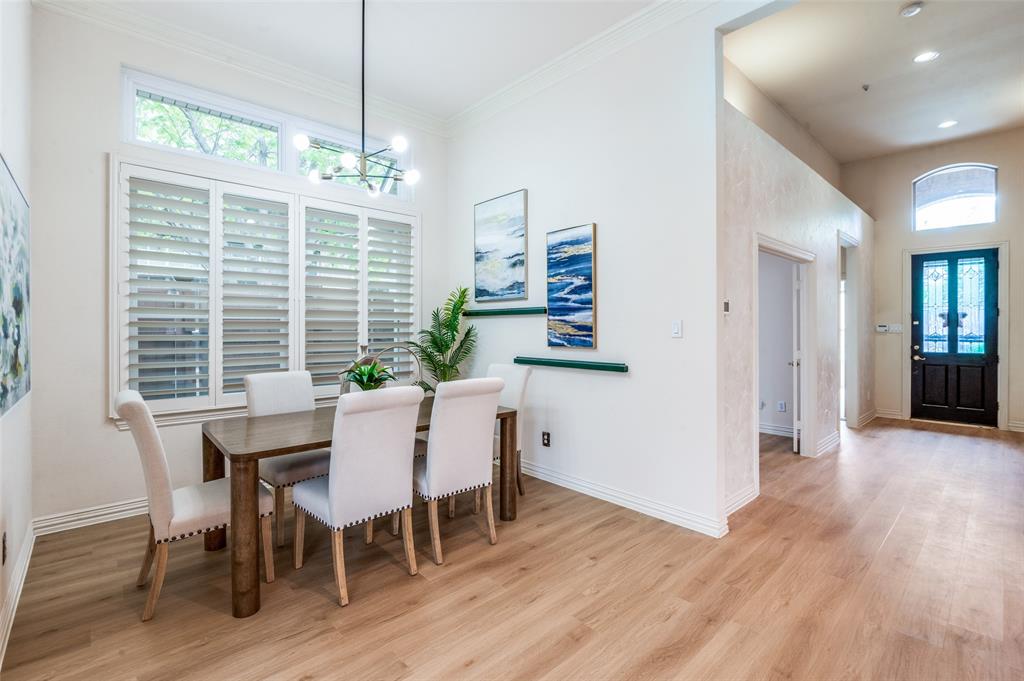 3752 Park Place Addison, TX 75001 - Photo 7 of 25 The dining area features light wood flooring, white walls, and a large window with white shutters and an upper transom window