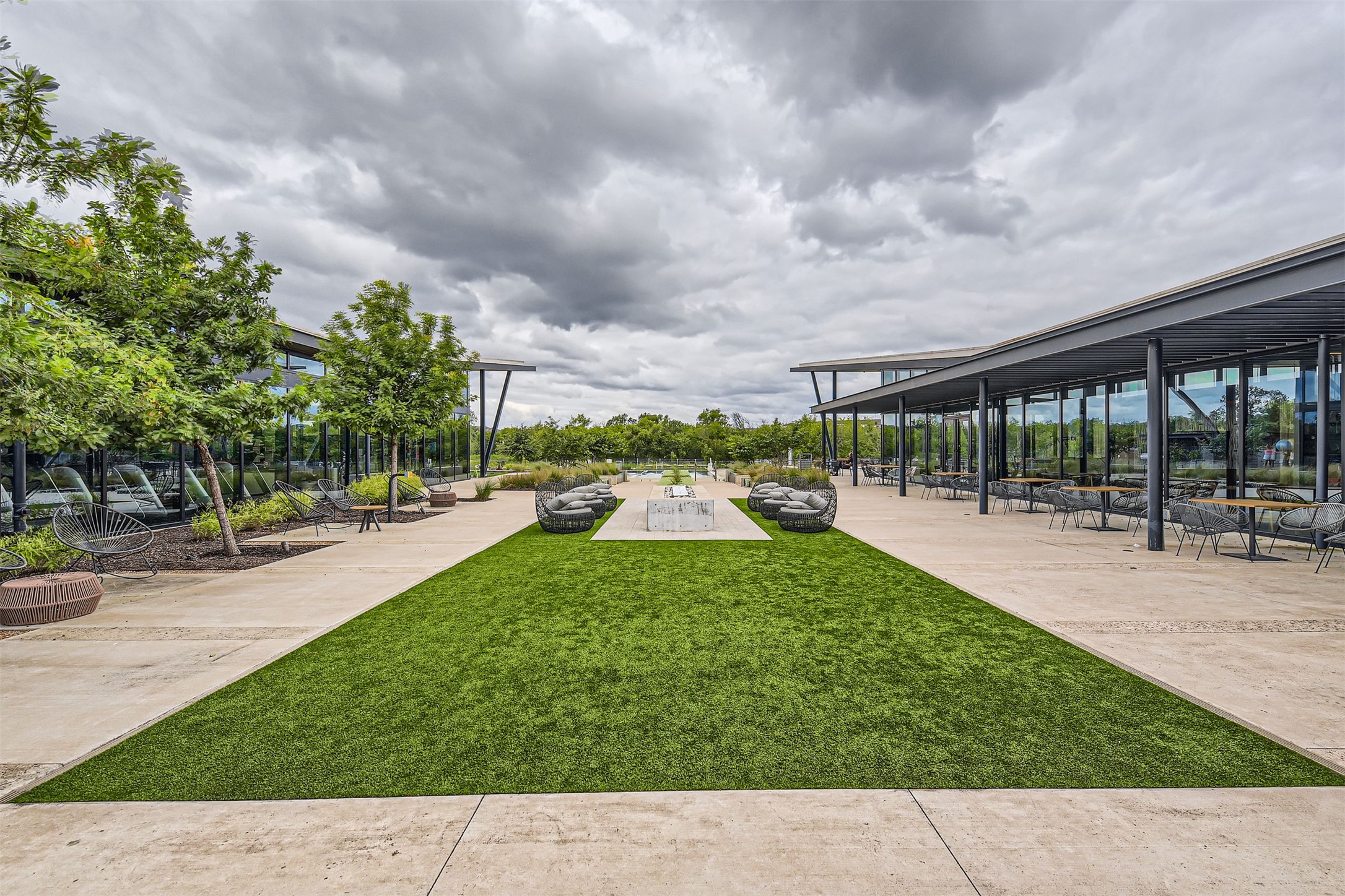 8313 Spire View Austin, TX 78744 - Photo 28 of 33 An inviting outdoor space features an artificial turf walkway leading to a central gathering area.