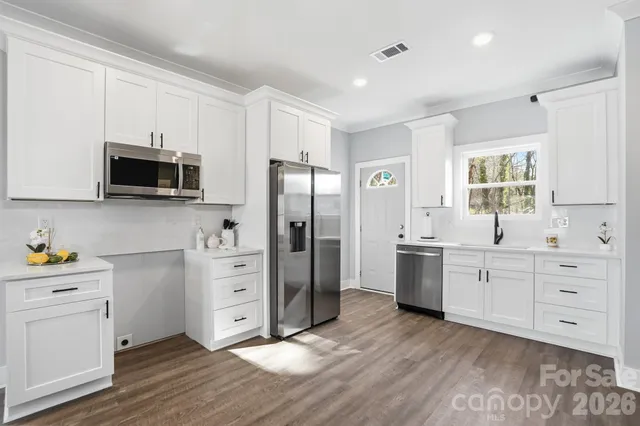 a kitchen with a refrigerator and cabinets