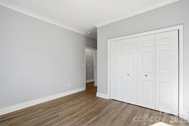 a view of walk in closet with wooden floor