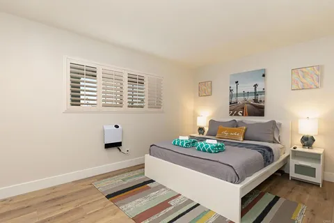 a bedroom with a bed table and a window