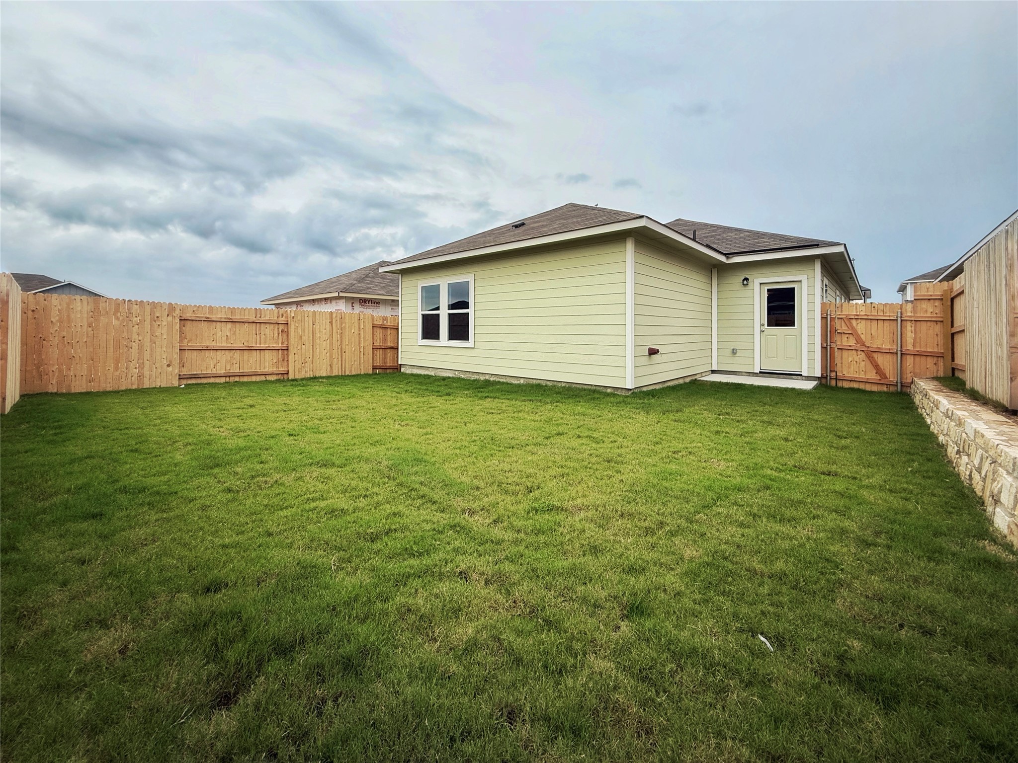 2714 Towy Road Manor, TX 78653 - Photo 18 of 22 A generous lawn and sturdy wood fencing define this home's private outdoor area.