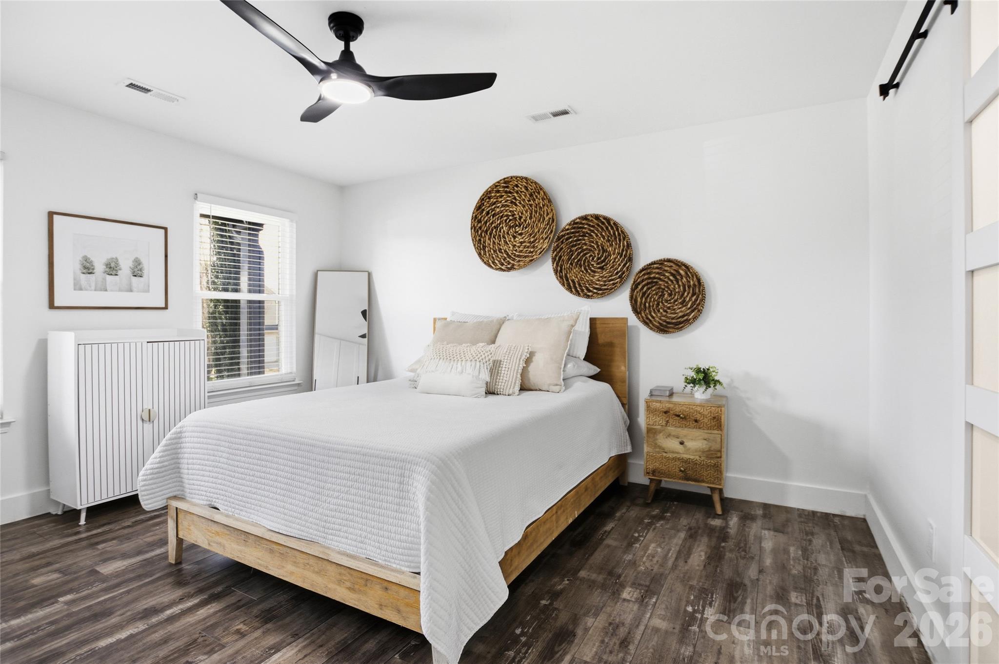 3056 Brookchase Boulevard Fort Mill, SC 29707 - Photo 12 of 23 a bedroom with a bed and a chandelier
