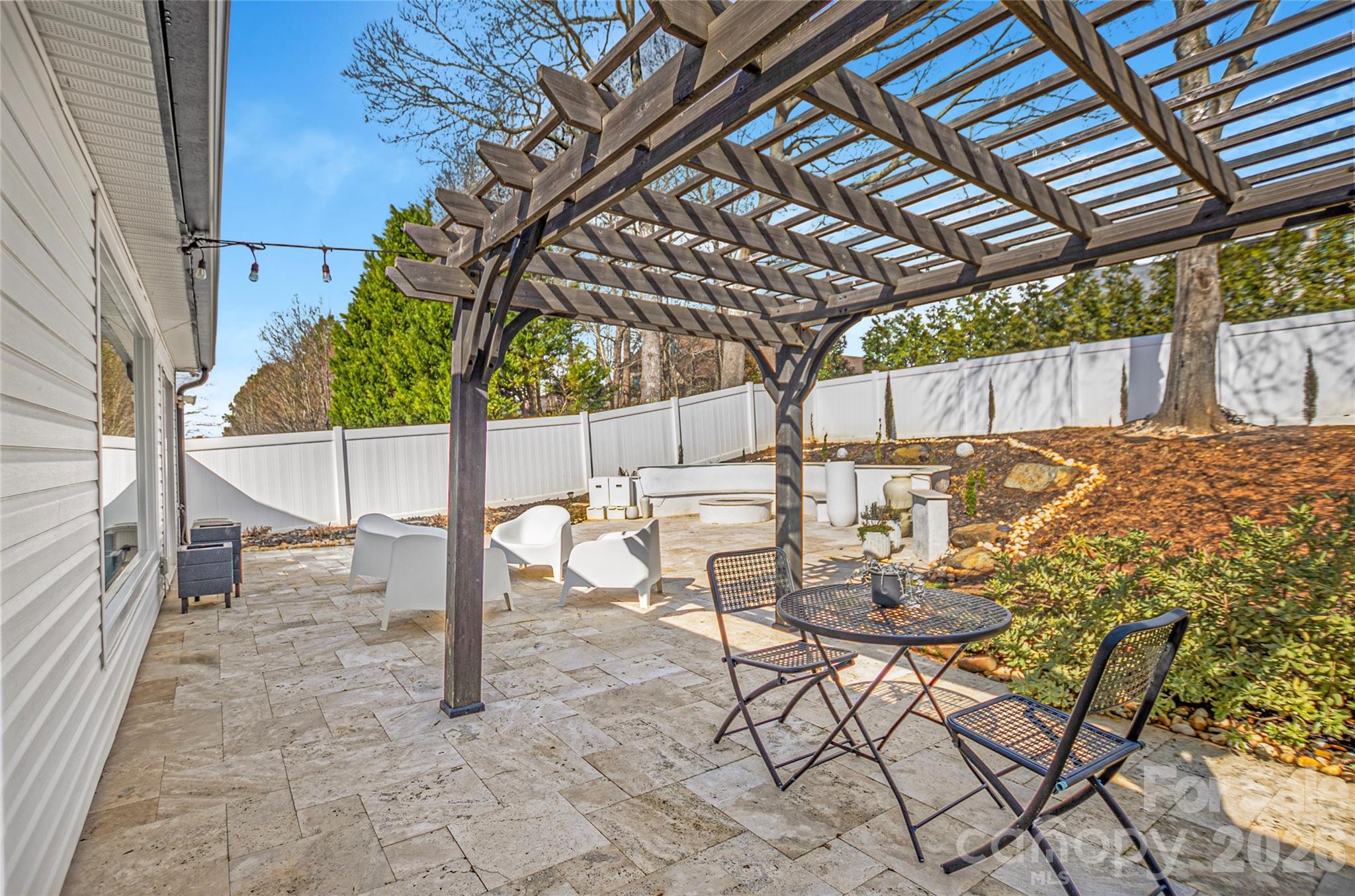 3056 Brookchase Boulevard Fort Mill, SC 29707 - Photo 20 of 23 a view of a backyard with table and chairs with wooden fence