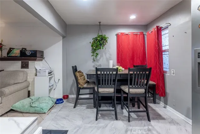 a dining room with furniture and a potted plant
