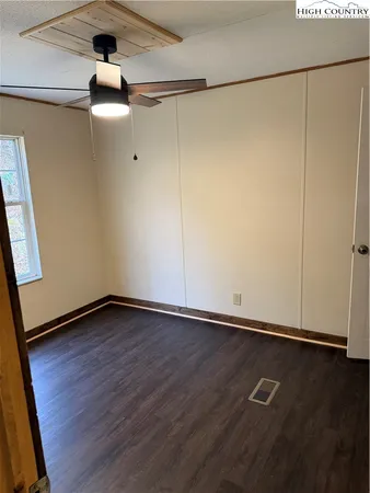 an empty room with wooden floor